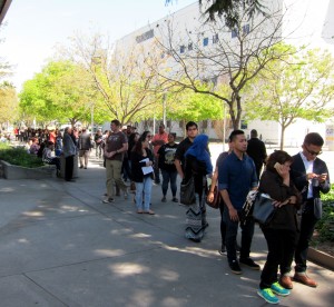 People waiting to receive free citizenship advice and application help in line in front of the Main Gym at San Jose City College on Saturday, April 2. (Photo by Sharon Simonson)
